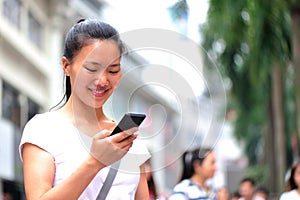 Asian woman use smart phone at shopping street
