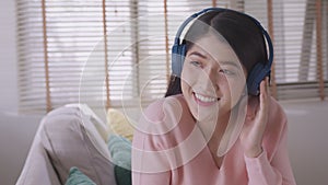Asian woman uses her smartphone. uses headphones to listen to music Enjoying a song or listening to a meditation audio course