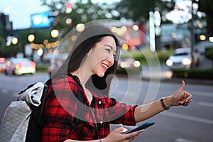 Asian woman using application of taxi service app on smart phone.