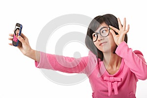 Asian woman using a cell phone to take a selfie isolated on white background