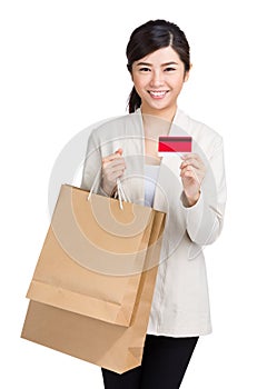 Asian woman using credit card with shopping bag