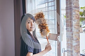 Asian woman using a dust brush,Hands of housemaid,dusting