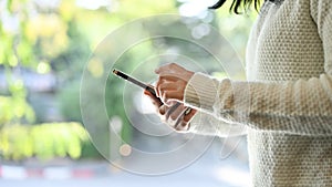 An Asian woman using her smartphone. close-up image