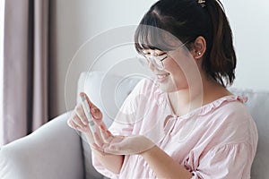 Asian woman using lancet on finger for checking blood sugar level by Glucose meter, Healthcare and Medical, diabetes, glycemia photo
