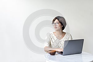 Asian woman using laptop browsing searching