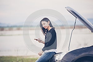 Asian woman using mobile phone while looking and Stressed man si