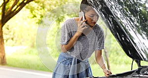 Asian woman using mobile phone while looking and Stressed man si