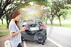 Asian woman using mobile phone while looking and Stressed man si