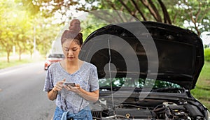 Asian woman using mobile phone while looking and Stressed man sitting after a car breakdown on street