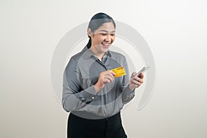 Asian woman using smartphone with hand holding credit card