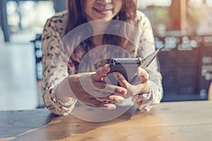 Asian woman using smartphone shopping online website on smartphone with smiling face. Happiness asian woman holding cellphone