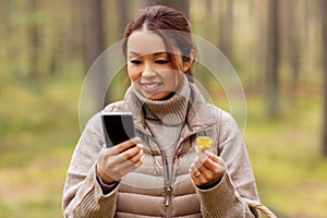 asian woman using smartphone to identify mushroom