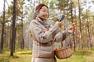 asian woman using smartphone to identify mushroom