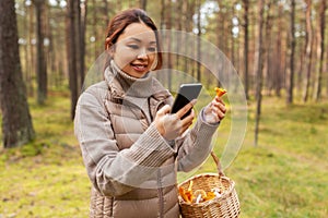 asian woman using smartphone to identify mushroom