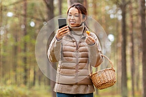 asian woman using smartphone to identify mushroom