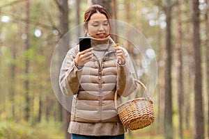 asian woman using smartphone to identify mushroom