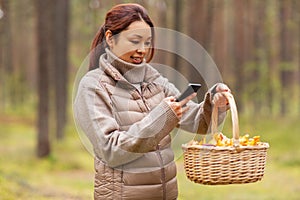 asian woman using smartphone to identify mushroom