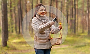 asian woman using smartphone to identify mushroom