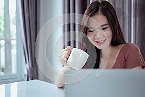 Asian woman video conference user interface with laptop computer remotely working from home