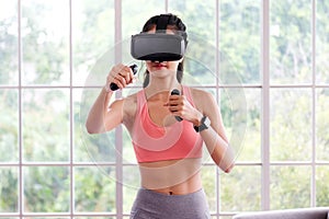 Asian woman virtual reality headset while exercise at home, Healthy asia girl wearing vr glasses for interactive exercise, e sport