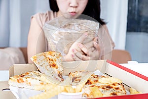 Asian Woman Vomiting and Indigestion Due to Overeating Pizza, bulimia, concept photo