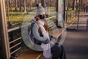 Asian Woman Waiting For Bus At Bus Stop In City Street And Wearing Face Mask Protect In Winter