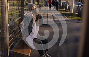 Asian Woman Waiting For Bus At Bus Stop In City Street And Wearing Face Mask Protect In Winter