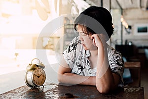 Asian woman waiting in coffee shop cafe with clock