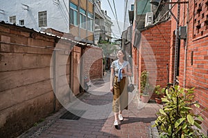 Asian woman walking in the narrow alley.