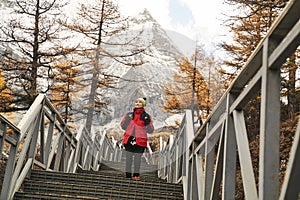 Asian woman walking on steps at the foot of mount chenrezig