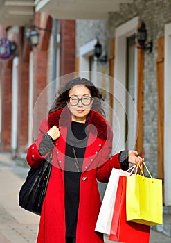 An Asian woman walking in the street