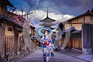 Asian woman walking Yasaka in street near Pagoda in Kyoto, Japan