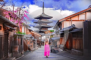 Asian woman walking Yasaka in street near Pagoda in Kyoto, Japan