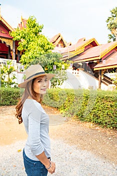 Asian woman with Wat Sri Rong Muang background in Lampang province