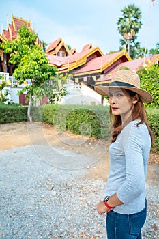 Asian woman with Wat Sri Rong Muang background in Lampang province