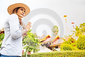 Asian woman with Wat Sri Rong Muang background in Lampang province