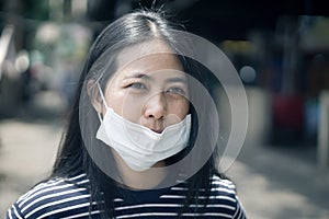 Asian woman wear protective face mask protect covid-19.