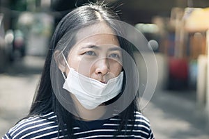 Asian woman wear protective face mask protect covid-19.