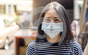 Asian woman wear protective face mask protect covid-19.