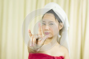 Asian woman wear a skirt to cover her breast after wash hair, Wrapped in Towels After Shower and giving gesture sign, symbol with