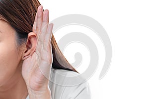 Asian woman wear white t-shirt  hearing loss or hard of hearing and  cupping her hand behind her ear isolate on white background