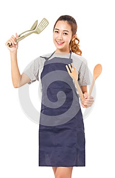 Asian Woman Wearing Apron And Showing Cooking Tools.