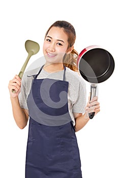 Asian Woman Wearing Apron And Showing Pan With Utensil.