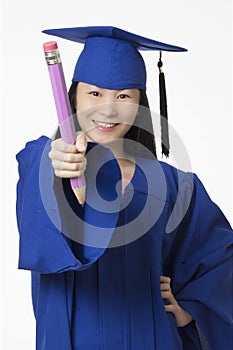 Asian woman wearing blue graduation holding pencil isolated whi