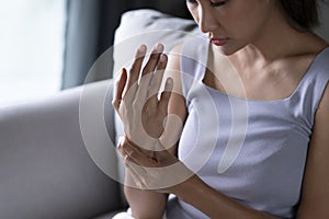 Asian woman wearing casual clothes suffering pain on hands and fingers, arthritis inflammation