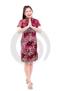 Asian woman wearing chinese dress cheongsam with gesture of cong