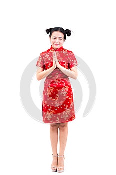 Asian woman wearing chinese dress cheongsam with gesture of cong