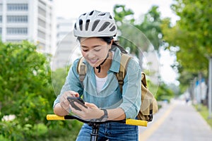 Asian woman wearing comfortable casual clothes Riding a bicycle in the park with copy space