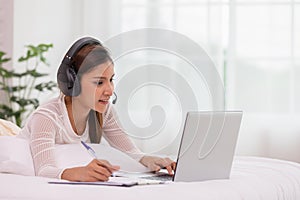 Asian woman wearing earphone and meeting in VDO call conferennce photo
