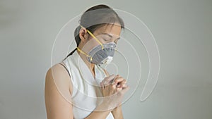 Asian woman wearing face mask for protect coronavirus covid-19. Pray at home, Church online, Praying hands, Worship at home